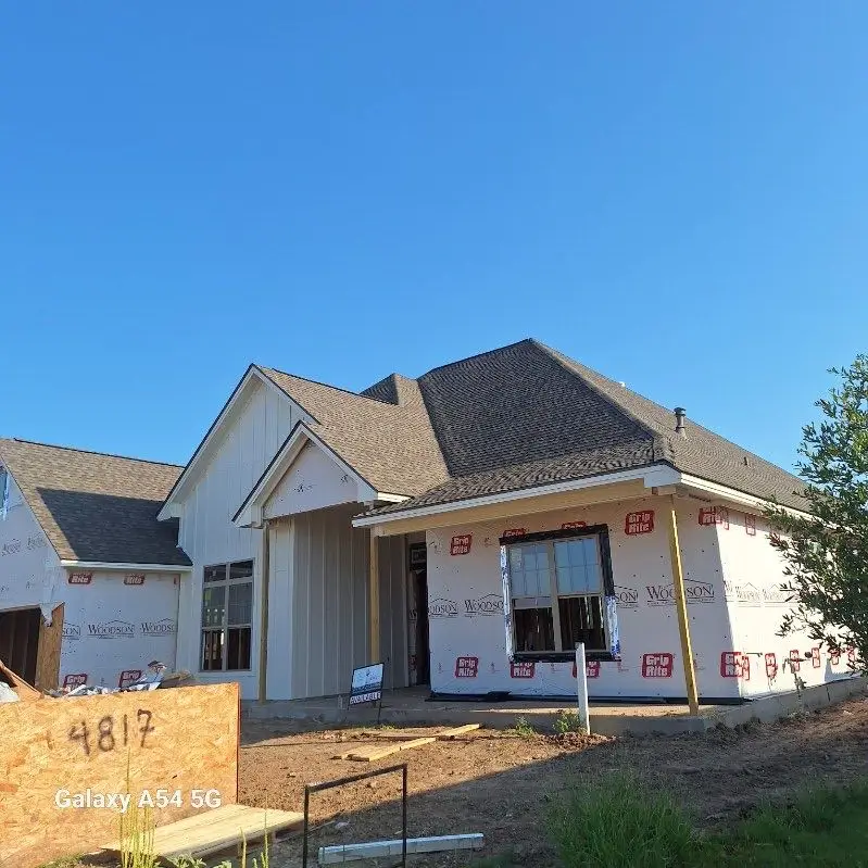 New construction home framed and wrapped, ready for roofing in Central Texas